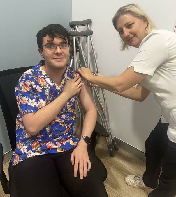 Leo Farrell getting his flu shot from Cowra pharmacist Suzie Nash
