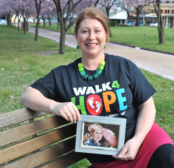 ​FOR MUM: Record attempt and fund raising organiser Rachael Brooking with a photo of her mum and fellow redhead, Frances Kelly. 
