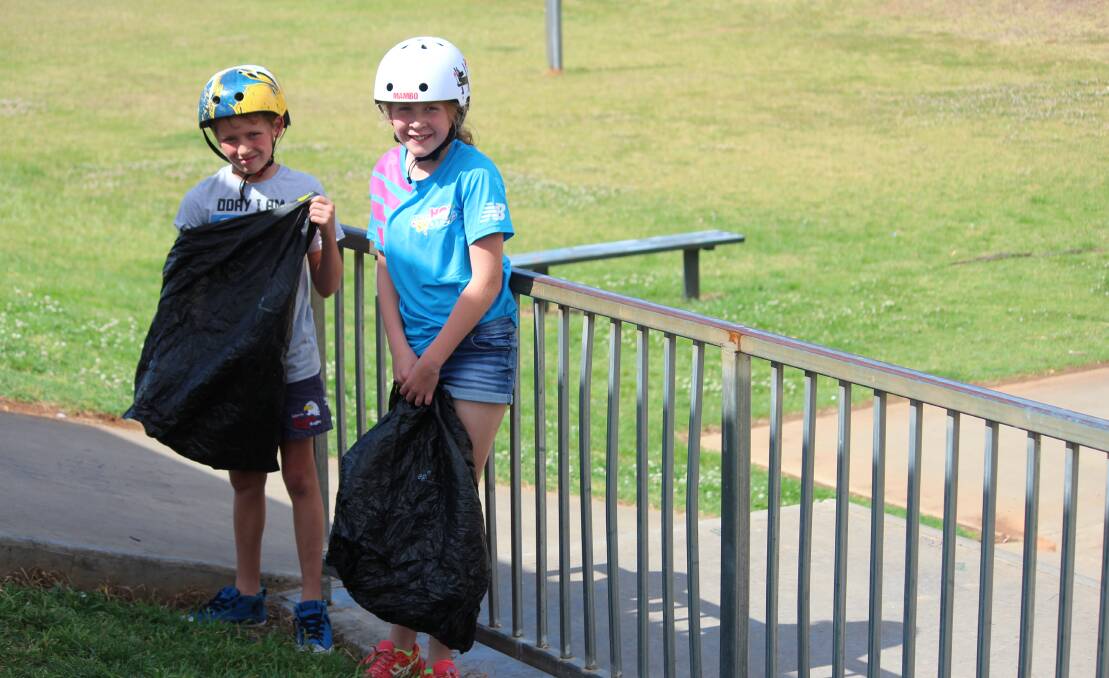Georgia and Hugh Williams of Lachlan Street cleaning up rubbish at Cowra's Skate Park.