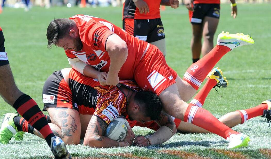 STAR POWER: NRL premiership winner George Rose brings down Andrew Fifita in last year's Knockout. Photo: DAILY LIBERAL
