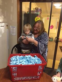 Rowena Lefever and Charlie Hampton draw the Cowra Special Needs Services Flexible Options Father's Day raffle. 