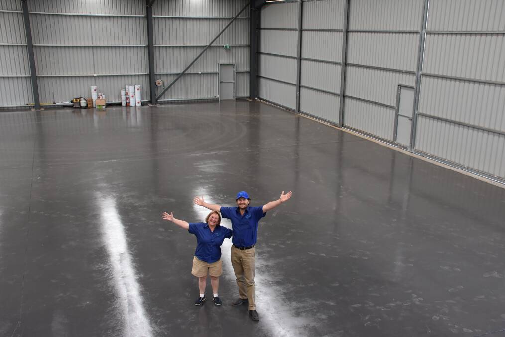 Lyn Gray and Mark Dixon from Fly Oz in their brand new hangar at Cowra Airport. 