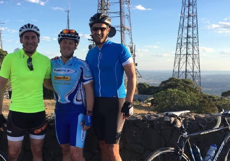 Nick ‘Hilly’ Johnston, Brendan Garard and Andrew Price catching their breath at the top of Orange’s spectacular Mount Canobolas during the Royal Far West Ride for Country Kids. 
