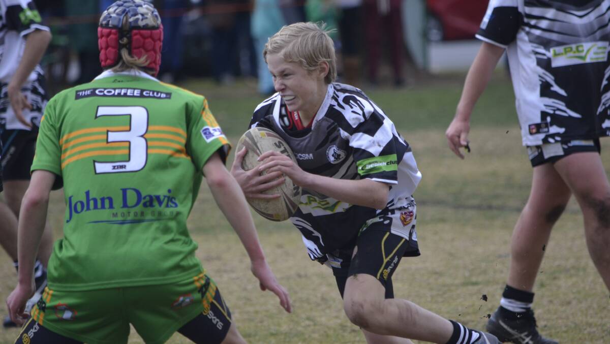 Cowra try scorer Luke Kinsey makes a determined run against undefeated Orange CYMS on Saturday.