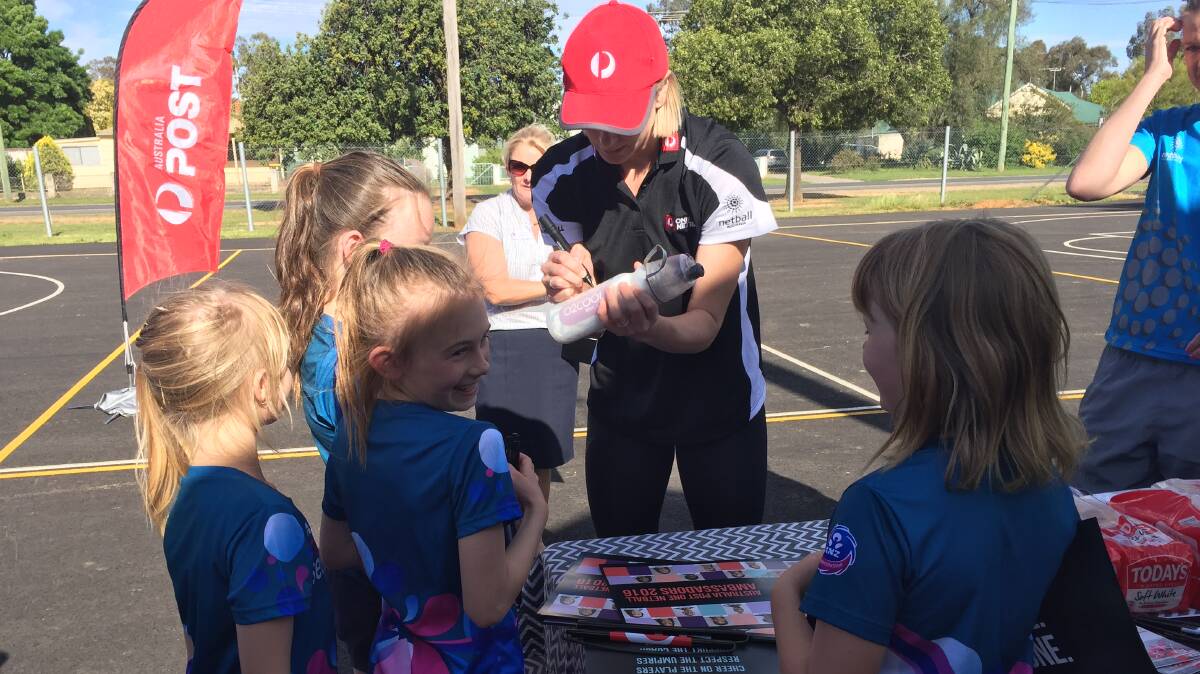 Australian Diamond Clare McMeniman takes time to sign autographs at Canowindra's netball courts last Wednesday.