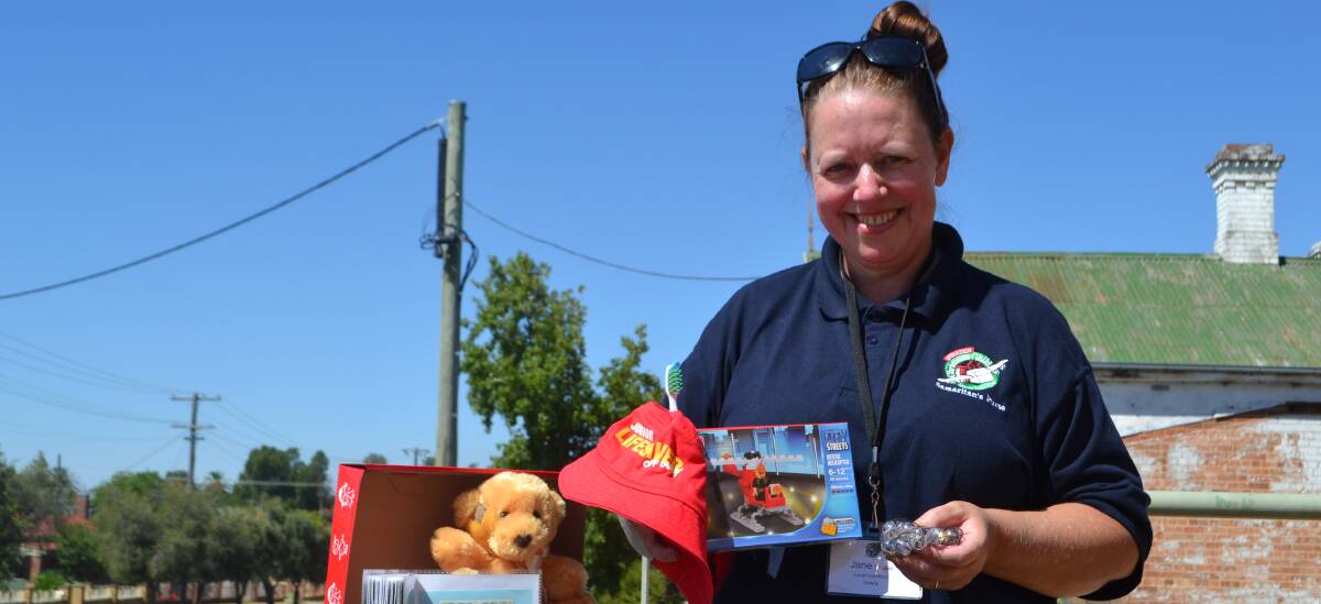 Jane holds a number of goods that will be packed in shoeboxes and distributed to kids in Fiji.