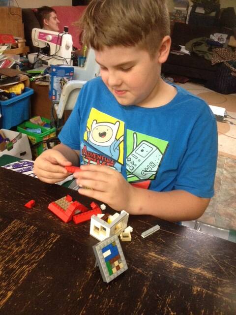 Pictured working on his masterpiece, Cowra boy Zachary Graham is a Lego enthusiast who will be getting involved at the exhibit.