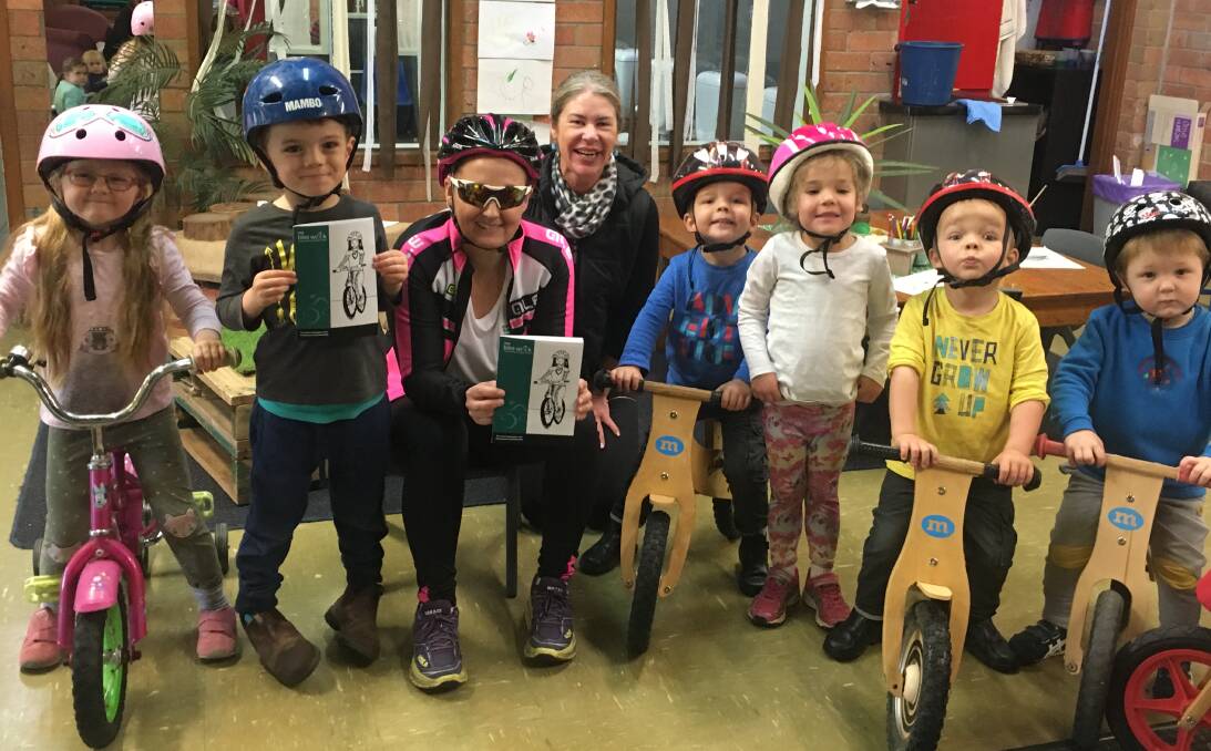Olive Hodder, Jock Morgan, Tabitha Jones, Lisa Roberston, Josh Launders, Lucy James, Sam Launders and Eli Hodder celebrate NSW Bike Week at Carinya Early Childhood Centre.