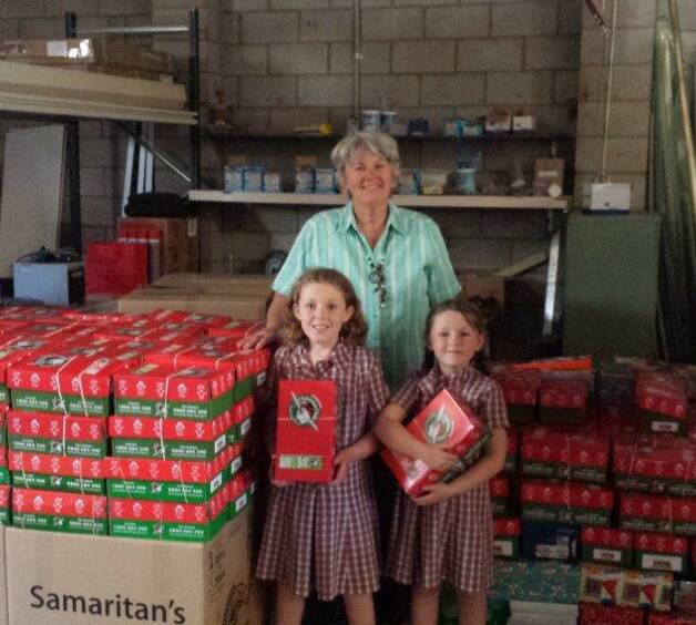 Barbara Curtis and granddaughters, Sarah and Melissa with the Christmas Boxes to be sent.