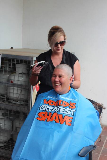 Nat Crutch shaves off Kellie Johnstone's hair to raise funds for the Leukaemia Foundation. 