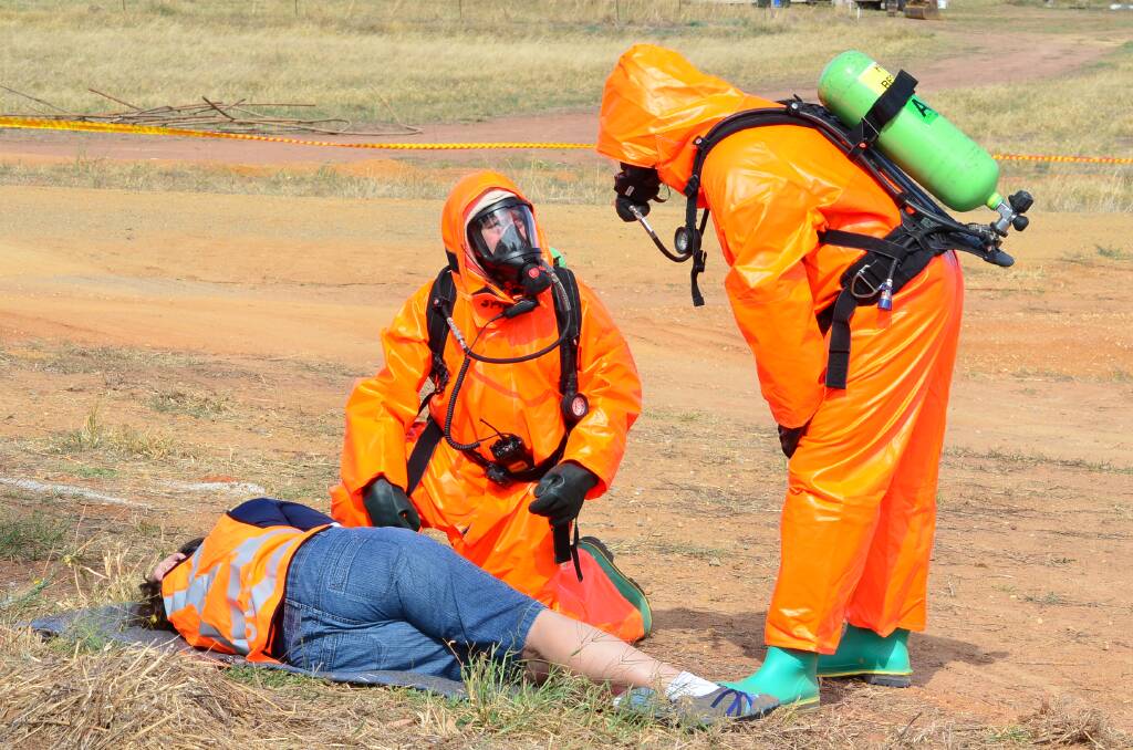 Aaron Buckanen and Stephen Overman practice assessing a mock casualty (played by Lisa Lette from Cowra SES) during the exercise.