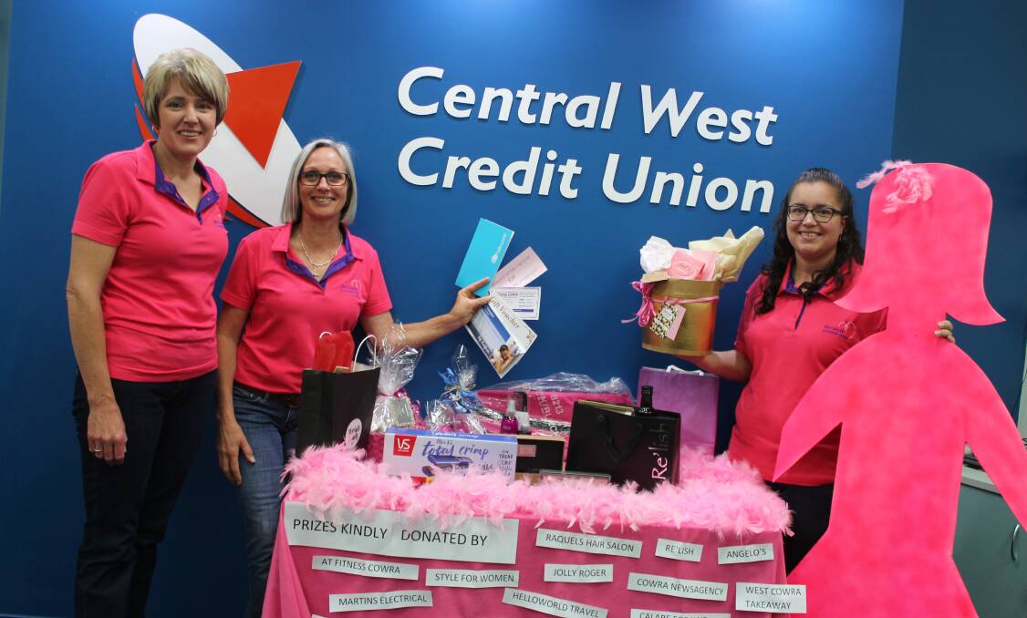 Leanne Mikoda, Leanore Smith and Kristy Quinn with some of the prizes donated. The team will be supporting the Breast Cancer Awareness Evening on October 18. 