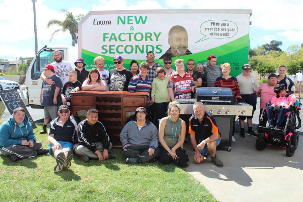 Clients and staff of Cowra Special Needs Services receiving the donations from Cowra Factory Seconds.