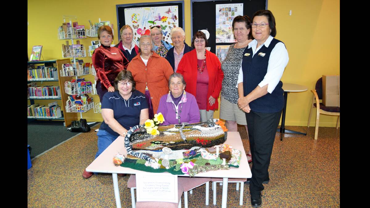 Cowra Special Needs Social Support Group has donated their 'Reading Log' knitted creation to Cowra Library for children to enjoy. Front: Jenny Friend, co-ordinator at Cowra Special Needs Social Support group, Gail Alchin and Cowra Librarian, Caroline Eisenhauer. Back: Volunteers Doreen Harmon and Kim Withers and knitters, Veronica Coffee, Betty Elsley, Isobelle Dolbel, Rosemary Bridge and Yvonne Porter.