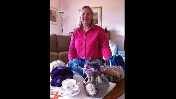 Kim Withers with some of her fabulous tea cosies. Photo supplied.