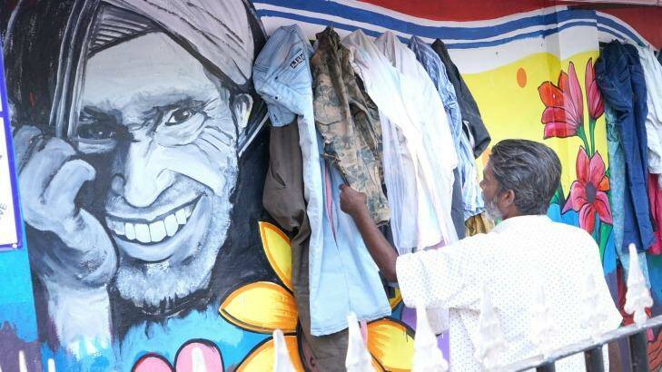 A man checks out a garment left at the Wall of Kindness in Bhilwara, India.  Photo: Gopal Kamad