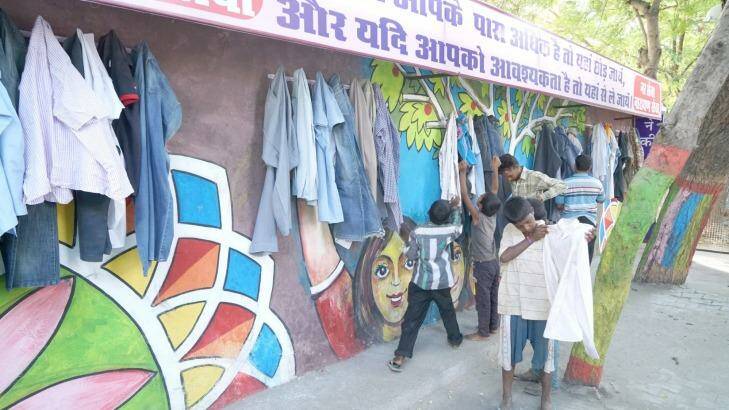 Children help themselves to donated items at the Wall of Kindness in Bhilwara, India. Photo: Gopal Kamad