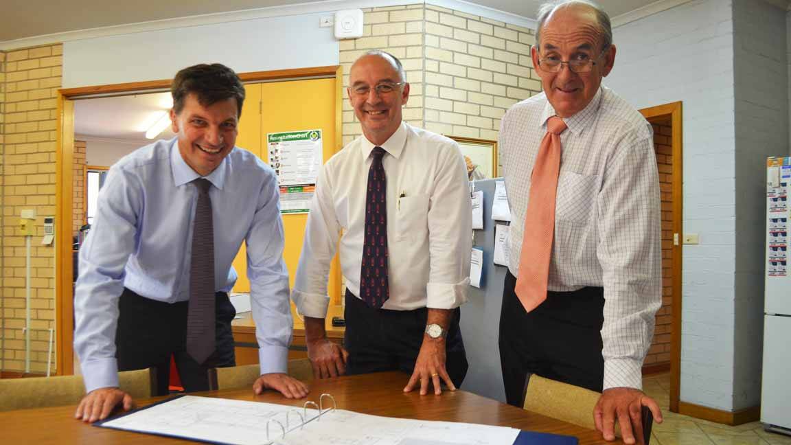 Federal Member for Hume Angus Taylor, St Raphael's Central School principal Michael Gallagher and Cowra mayor Cr Bill West survey the plans which will more than double the existing footprint of the school.