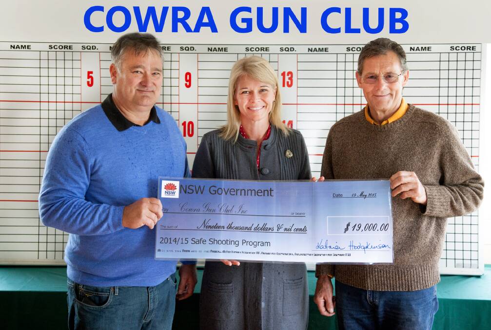 Cowra gun club s Richard Johnstone and John Finn with Katrina Hodgkinson (centre) with the funding cheque. Photo Kristy White.