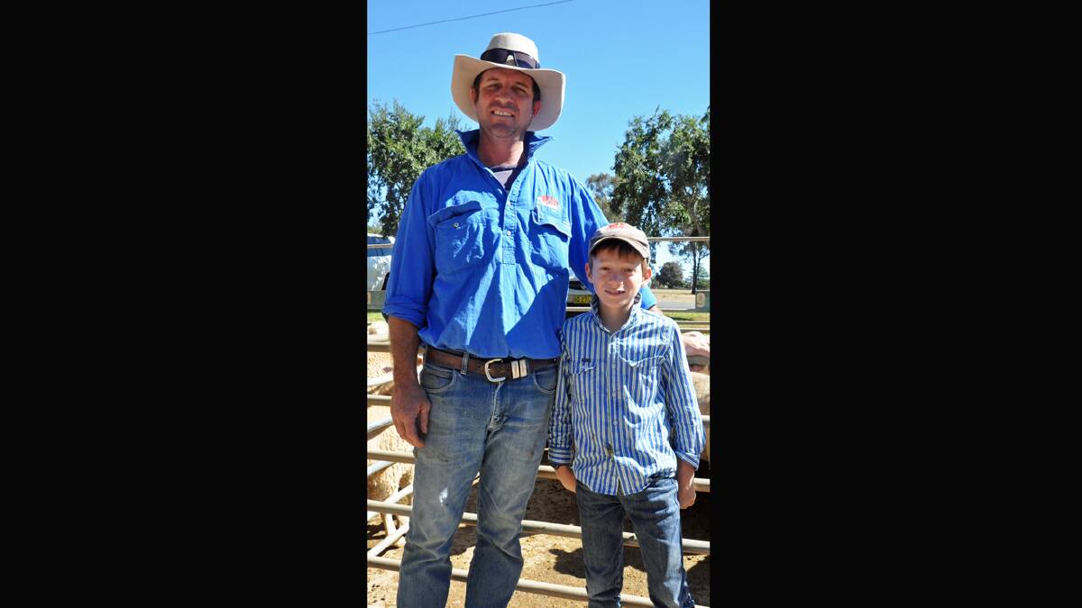 Norman C. Bellamy director Damien Stephenson, Cowra, pictured with son Jock at the Cowra saleyards recently said there's been no repercussions locally from JBS Australia's processing cuts.