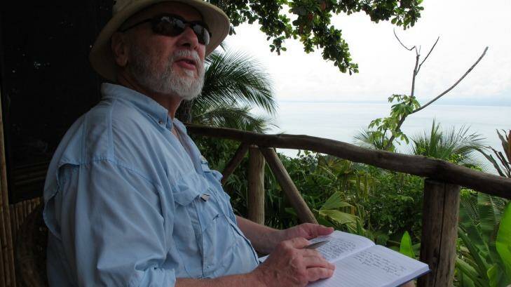 Professor Rick Shine taking field notes in the tropics.  Photo: University of Sydney