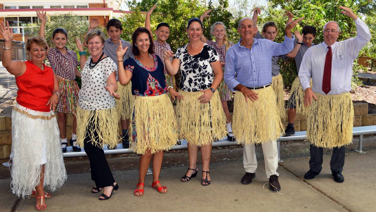 To help promote the record attempt, teachers and pupils from Mulyan Public School donned the traditional grass skirt of the Pacific Island for a time-honoured Tongan Dance. From left: Festival Chairperson, Councillor Ruth Fagan, Hannah Stone, Festival Coordinator, Kylie Wood, Rohan Wilson, teacher Gina Baratto, Mackenzie Crook, teacher Kellie Statham, Zoe Browne, Mayor Bill West, Bailey Callaghan, Bailey Beale and Principal John Smith.