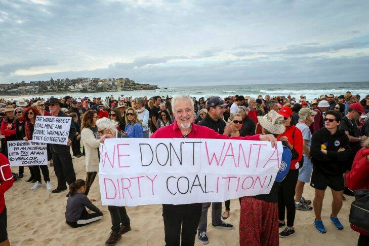 Narayan Van de Graaf from Elizabeth Bay woke up at 3am inspired to make a banner and join over 1000 people at 9am on Bondi Beach, to protest against the Adani coal project on Saturday 7th of October 2017. Photograph by Katherine Griffiths