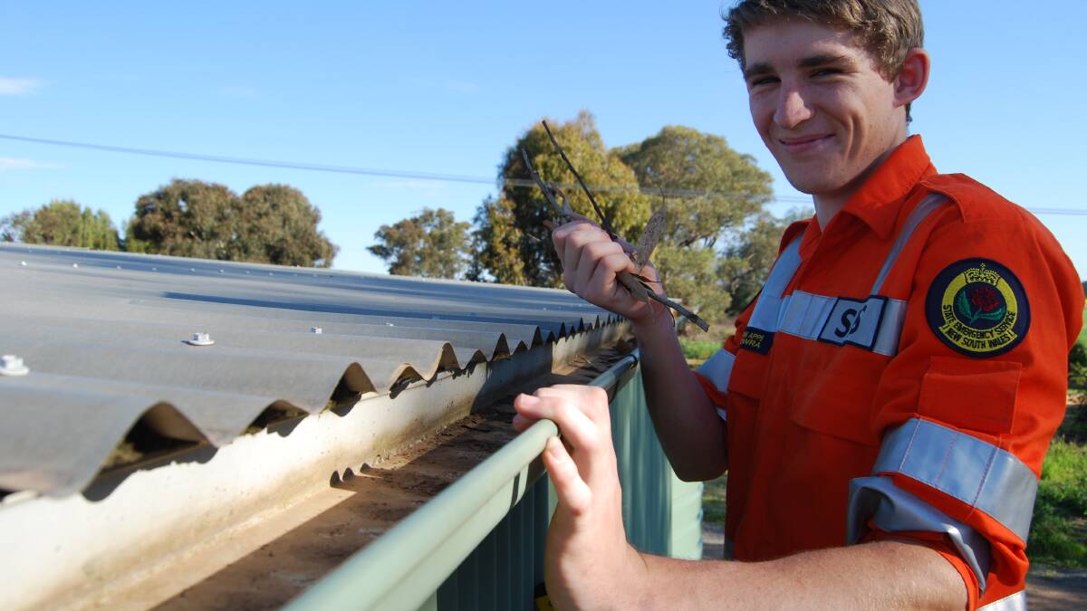 Cowra SES member Ryan Apps clears some gutters. FILE PHOTO
