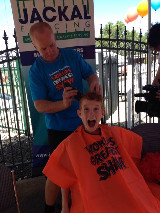 BRAVE: Cooper Hale, 10, has his locks shaved by his dad, Jamie. Picture: CONTRIBUTED
