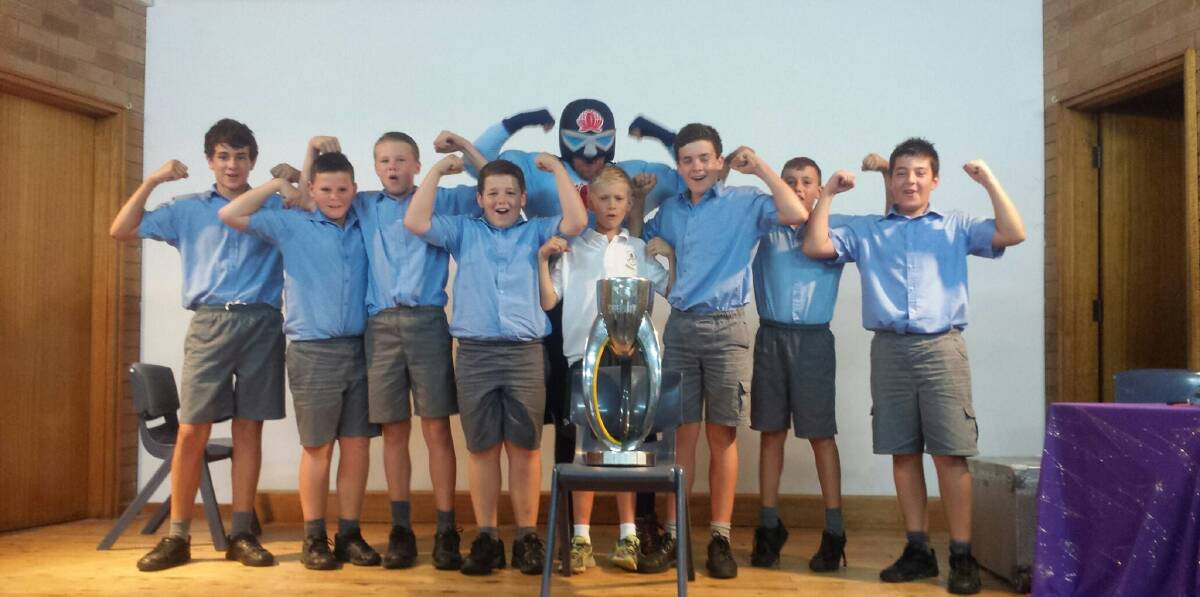 St Raphael s students with the NSW Waratah's Mascot, "Tah Man" and the Super Rugby premiership trophy.