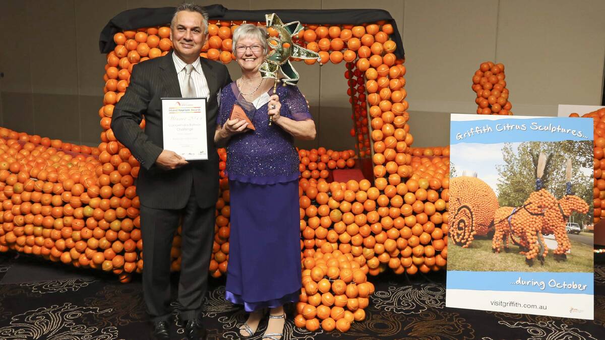  Jan Kerr from the Canowindra Balloon Challenge accepting the Gold Award for Festivals and Events at the 2014 Inland Tourism Awards The award was presented by John Sutherland from the Australian Senior. Photo by Brett Naseby.

