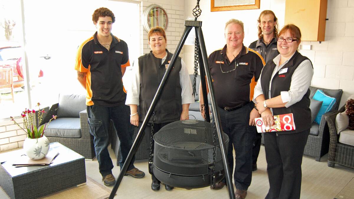 Cowra Furniture One staff Nathan Bourne, Robyn Day and Drew Bouffler with the
prize they've donated to the monster raffle. Coles staff member Olivia Howarth thanked the team for their donation.