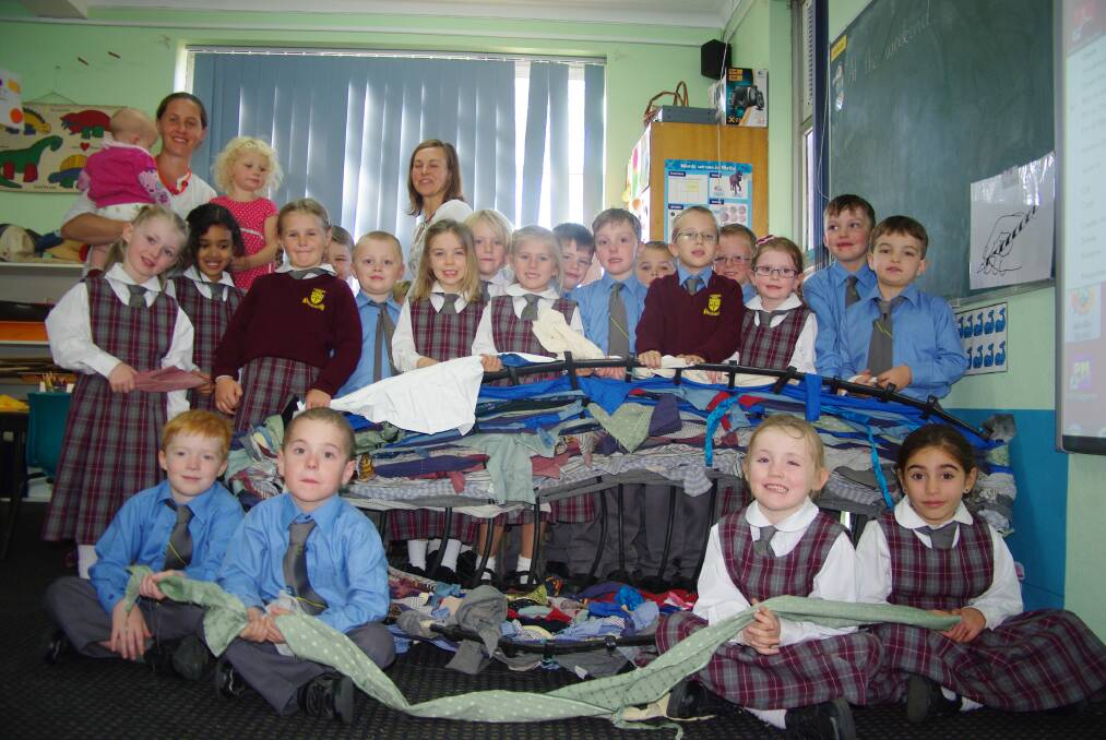 Mrs Finlay's kindergarten class proudly display their boat made out of shirts and bed sheets.