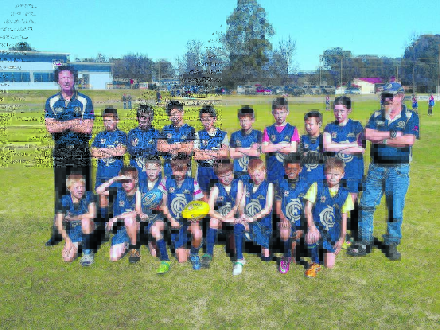 Cowra Blues under 11s with coach Kim Reid (left) and manager Mick Hill (right).