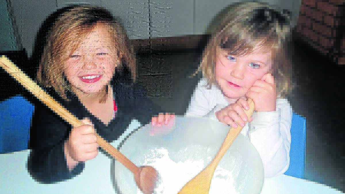 Annie-Leroux Riley and Abigail Thomas cooking in preparation for the Sam's Room cake stall at tomorrow's Fun Day in the Park.