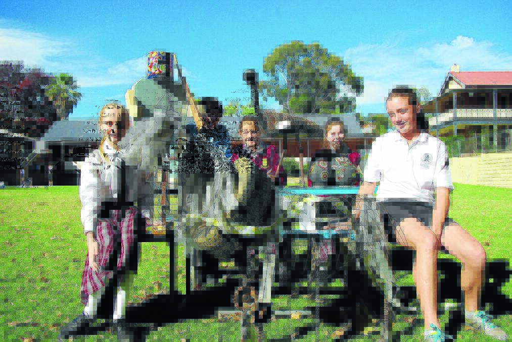 St Raphael's Central School students Amy Grant, Matt Wilkinson, Madeleine Cain, Julia Cains and Darcee Nixon with their entrants for this year's Recycled Art for Cowra Awards.