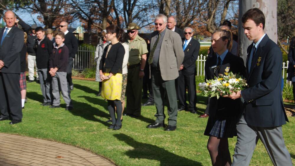 Cowra High School's Chris Devery and Gabriella Rhodes lay a wreath at the Australian War Cemetery.
