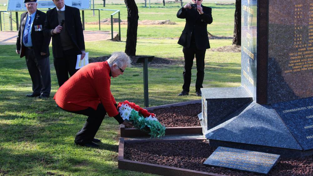Maria Bell lays a wreath at the prisoner of war campsite.