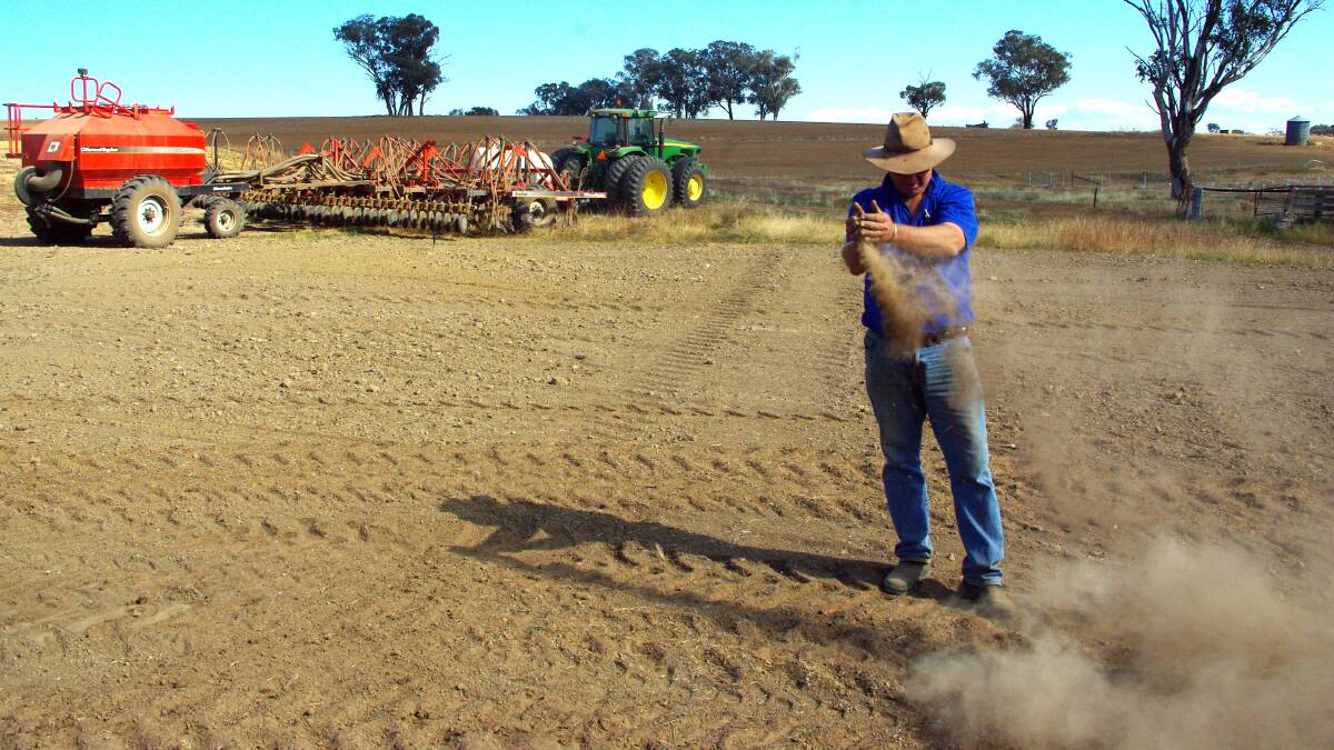 DUST BATH: John Roberts shows just how dry it is during a break in sowing yesterday afternoon, on "Greylands" north of Cowra. 