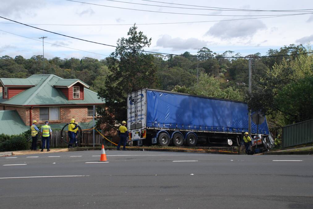 A semi-trailer, believed to be driven by a Cowra driver, has crashed into the front yard of a house in Springwood in the Blue Mountains. Photo: Ilsa Cunningham, Blue Mountains Gazette. (Flick across for more images). 