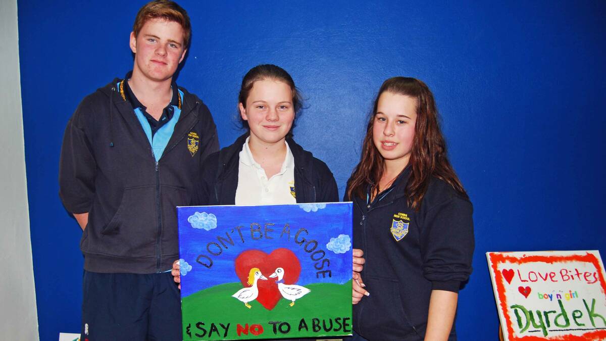 Liam Pierce, Sarah Burrell and Shaye Wallace with their winning message as voted by the students: 'Don't be a goose, say no to abuse.'