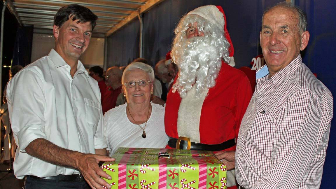 Member for Hume Angus Taylor with Millionaires Giveaway winner Josie Day, Santa Claus and Mayor Bill West.