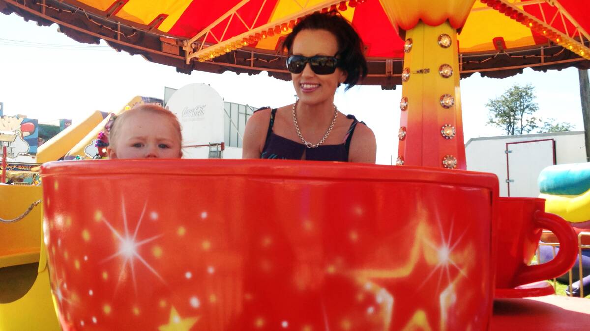 Jacinta McKay takes a spin on the teacups with mum, Melissa Hunt.