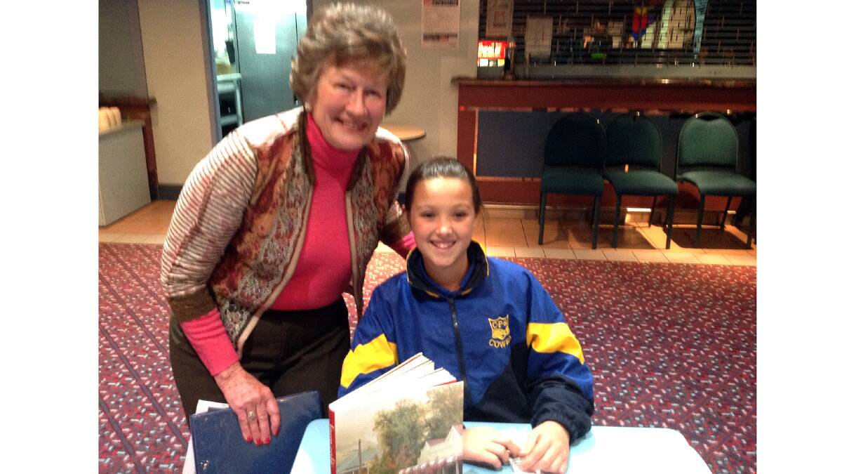 Millie Casey selling raffle tickets with Granny.