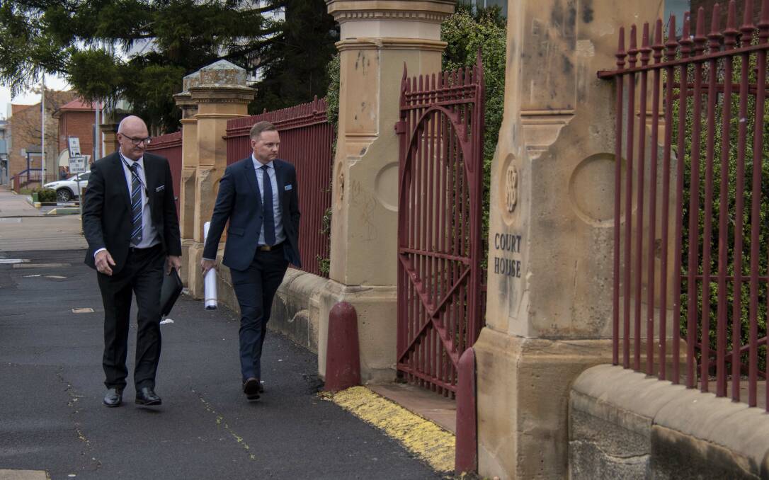  Detective sergeant Adrian Tighe (left) enters Dubbo Court for the first day of Kylie So's trial for Robert Dickie's murder. Picture by Belinda Soole
