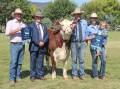 Auctioneer Daniel Croker, Goulburn, RNCAS president Rick Jones, Tim, Jemma and Molly Reid, JTR Cattle Company, Roslyn, with the donated steer.