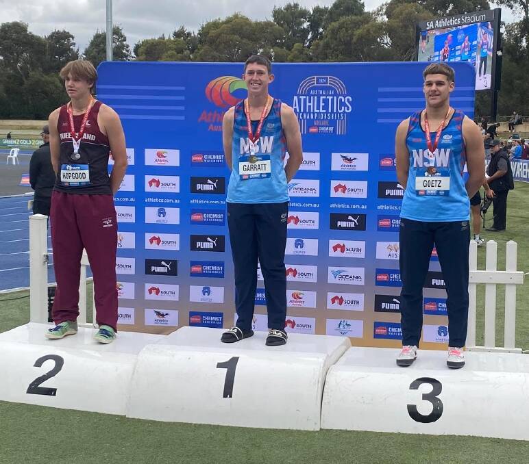 Ky Garrett (centre) on the podium at the Australian Athletics Championships