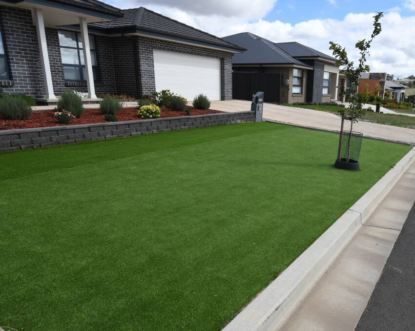 GREEN GRASS: Artificial turf at the front of a house in Scarborough Street in north Orange. Photo: JUDE KEOGH