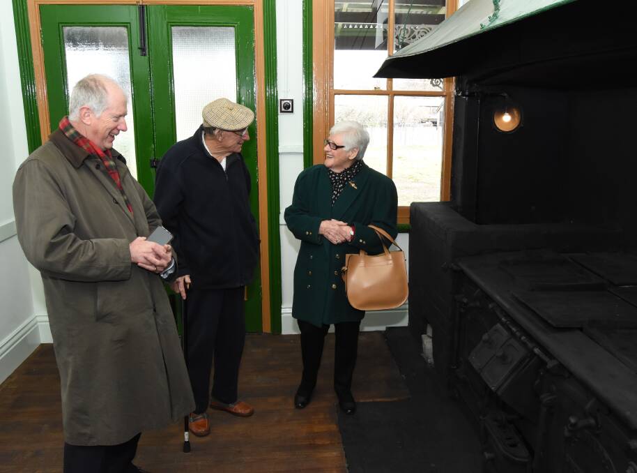 Good times: Chief executive of Sydney Trains Howard Collins with Vic and Dawn Smith in the old kitchen in Blayney Railway Station. 