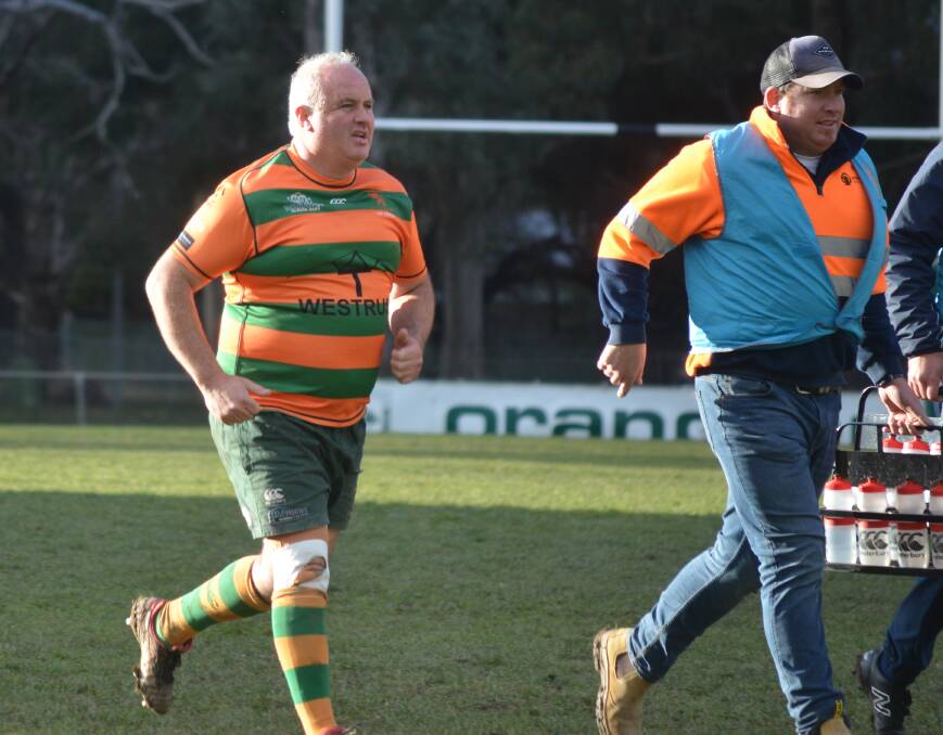 WHOOPS: Orange City's Darren Wooding found himself tackling the referee in first grade against Orange Emus, accidentally of course. Photo: LACHLAN HARPER